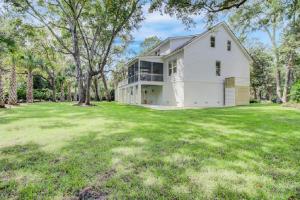 a large white house with a large yard at Fairway Oaks 33 by Wild Dunes, Home Close to Resort Core with Amenity Access in Isle of Palms
