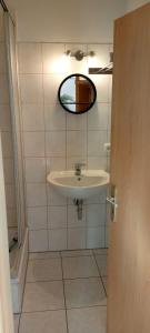 a bathroom with a sink and a mirror at Forrest Apartments in Freiberg Min stay 2 nights Max Number of Guest 1 Aprt 1 in Freiberg +6 photos