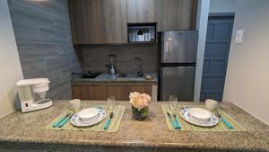 a kitchen with a counter with plates and utensils at Suite 618 Downtown Guayaquil- Centro de la Ciudad in Guayaquil