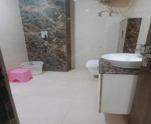 a bathroom with a sink and a toilet at Hotel ALVAA GRAND Near Delhi Airport BY-AERO HOME STAY in New Delhi