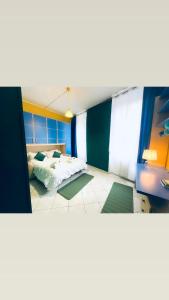 a large room with a bed and a bedroom with blue walls at JCK Tuscany Apartment in Livorno