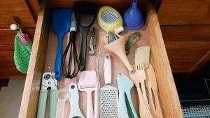 a drawer filled with lots of kitchen utensils at Down By The Sea, the beachfront Apartment in Puerto Coyote