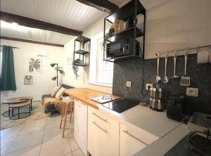 a kitchen with a counter and a table in a room at Le Viala, Studio dans le centre historique de Hyères in Hyères