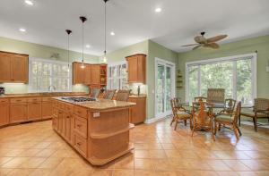 a kitchen with a table and a dining room at Fairway Oaks 42 by Wild Dunes, Home Close to Resort Core with Amenity Access in Isle of Palms