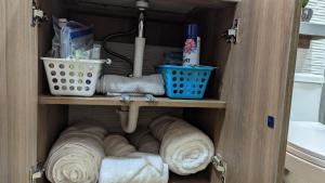 a cabinet with towels and other items in a bathroom at Suite 618 Downtown Guayaquil- Centro de la Ciudad in Guayaquil