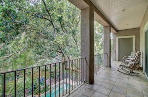 a balcony with a view of the woods at Fairway Oaks 42 by Wild Dunes, Home Close to Resort Core with Amenity Access in Isle of Palms