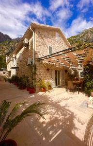 a building with a patio with a table and chairs at Holiday Home Nautica in Kotor