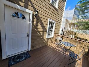 a porch with a white door and a chair at Private Getaway In Midtown 2bedroom- SLEEP 5 in Atlanta
