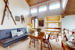 a living room with a couch and a table at Golden Eagle Lane 17 | Discover Sunriver in Sunriver
