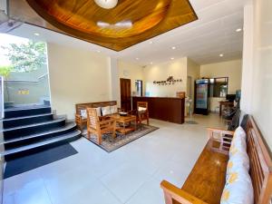een lobby met een trap en een tafel en stoelen bij Coron Vista Lodge in Coron