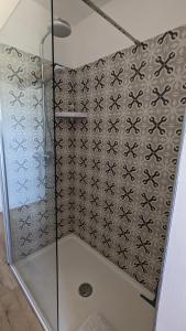 een douche met een glazen deur in de badkamer bij Chambre L à Tavel in Tavel