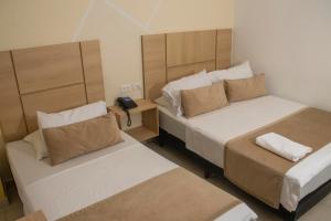Postel nebo postele na pokoji v ubytování Hotel Central
