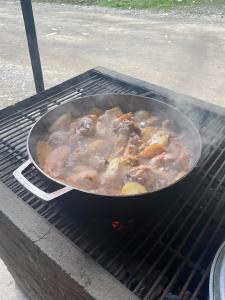a pan of food cooking on an outdoor grill at Cabañas el Portal in Santa Rosa de Cabal
