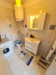 a small bathroom with a toilet and a sink at APARTMAN MARKO 2 in Novi Vinodolski