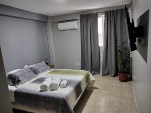 a bedroom with a bed with two white bowls on it at Suite 618 Downtown Guayaquil- Centro de la Ciudad in Guayaquil
