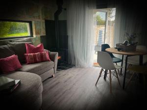 a living room with a couch and a table at The Stables at Ballyward Croft in Ardkeen