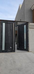 a building with two large glass doors on it at استديو انيق وراقي in Riyadh