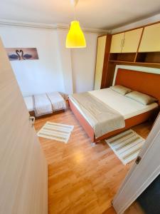 a bedroom with two beds and a yellow light at APARTMAN MARKO 2 in Novi Vinodolski