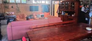 ein Wohnzimmer mit einem rosa Sofa und einem Tisch in der Unterkunft Route 114 in Acireale