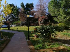 a street light next to a sidewalk in a park at le tamerici B&B in Ancona