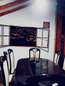 a dining room with a table and chairs and a window at Casa Familiar El Carmen in Cusco
