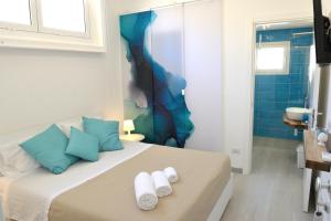 a bedroom with a bed with towels on it at Maricò B&B in San Vito lo Capo
