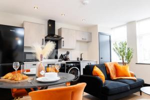 a kitchen and living room with a table and chairs at The Berriman Collection in Cardiff