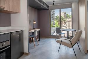 a kitchen and dining room with a table and chairs at Almasur Providencia in Santiago