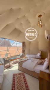 two beds in a room with a sign that reads buffalo at Wadi rum Bubble luxury camp in Wadi Rum