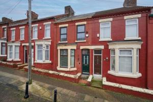 a row of red brick houses on a street at Home away from home in Liverpool