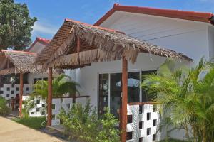 a house with a thatched roof at Vivi Bungalows Resort in Nai Harn Beach