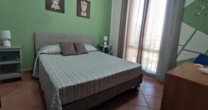 a bedroom with a bed with two pillows on it at Appartamento LG in San Vito lo Capo