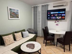 a living room with a couch and a table at Apartment Piko in Crikvenica