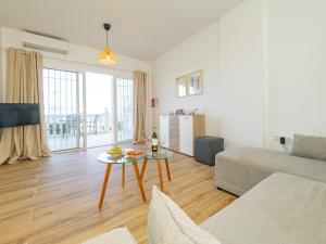 a living room with a couch and a table at Apartment on Beach Mijas in Mijas Costa