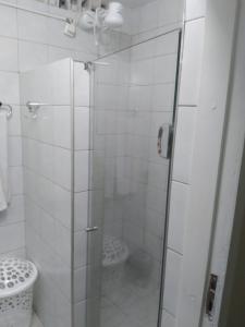 a bathroom with a glass shower with a toilet at Pousada Suítes Meireles in Fortaleza