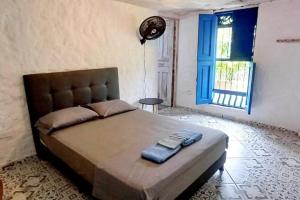 ein Schlafzimmer mit einem großen Bett mit zwei Handtüchern darauf in der Unterkunft Finca El Tagual Refugio Natural in El Chocho