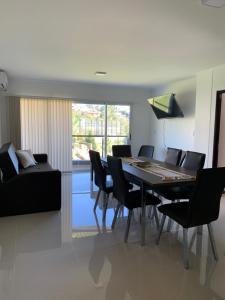 a dining room with a table and chairs and a couch at Veneto Village J in Cordoba