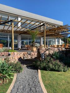 a patio with chairs and a stone wall at Veneto Village J in Cordoba