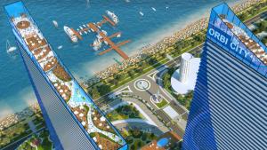 an aerial view of a city with buildings and the ocean at ORBI CITY SUITE in Batumi