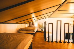 a room with two beds and a small room with at Black Tiger Seaside - Ferienwohnungen direkt am See in Garden