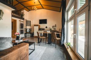 a living room with a couch and a table at Black Tiger Seaside - Ferienwohnungen direkt am See in Garden