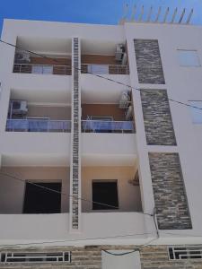 an apartment building with balconies on the side of it at Room Breakfast in Zarzouna