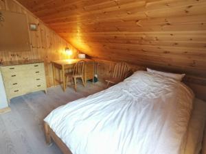 a bedroom with a bed and a table and chairs at Great house in Risør centre in Risør