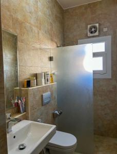a bathroom with a toilet and a sink at VILLA seeb 2 MIN walk to the beach in Seeb