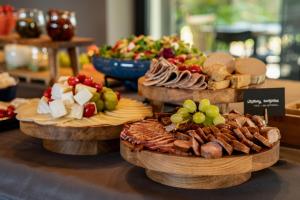 a display of different types of food on wooden plates at Rosa Style in Rowy