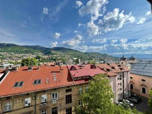 a view of the roofs of buildings in a city at Apartments Dani Free Parking in Sarajevo