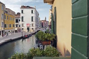 a view of a canal in a city with buildings at Hotel American-Dinesen in Venice