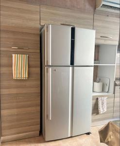 a stainless steel refrigerator in a kitchen at VILLA seeb 2 MIN walk to the beach in Seeb