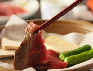 a piece of meat with a wooden stick sticking out at Hotel Sunny Valley in Otari +85 photos