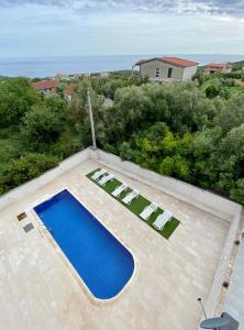 an overhead view of a swimming pool and two lounge chairs at Krimovica Sunset in Krimovice